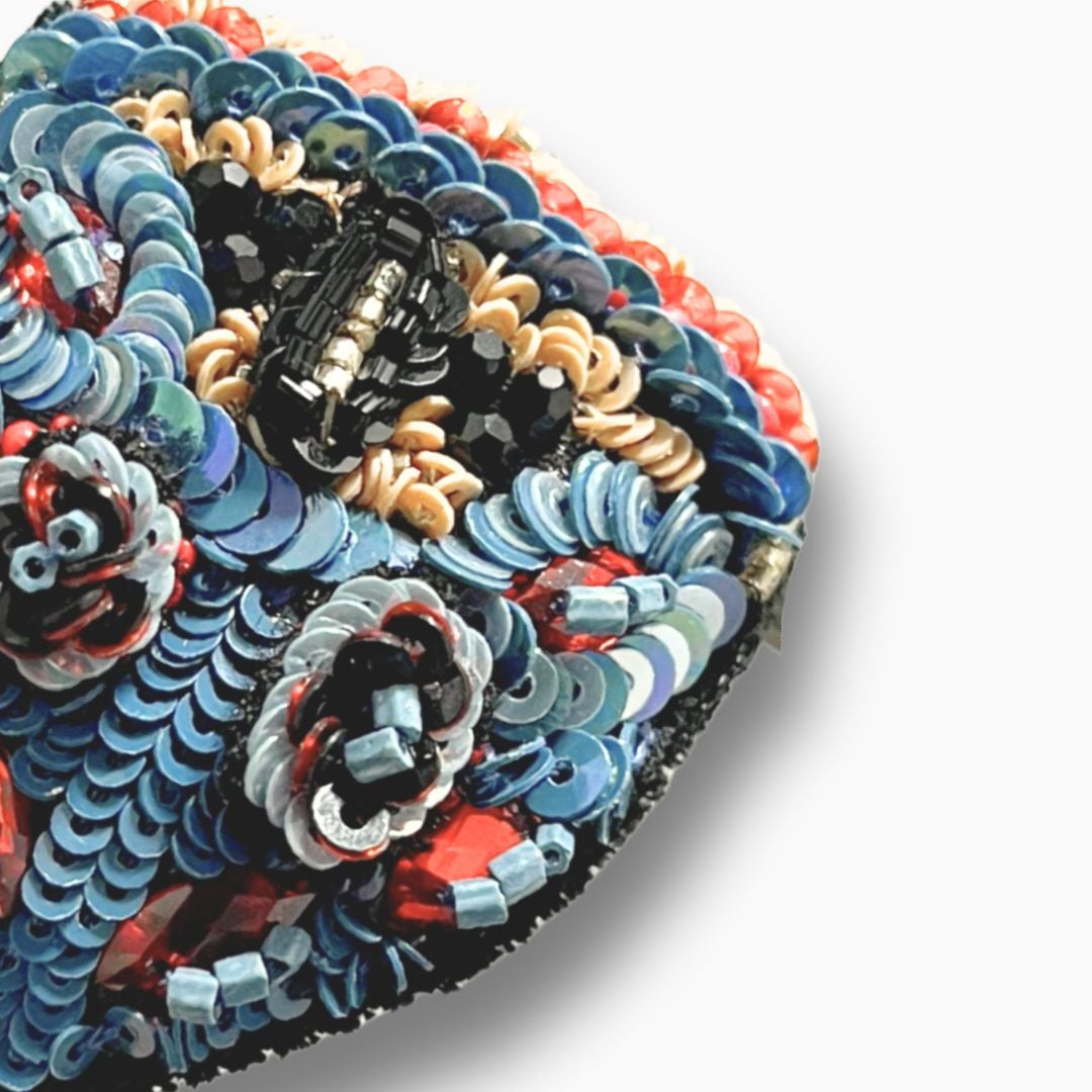 Colorful embroidered fabric with intricate patterns on a white background